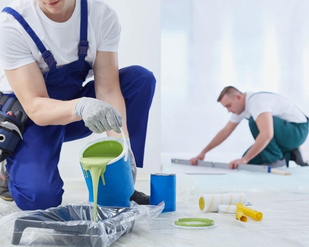 Man painting the walls and spilling the paint